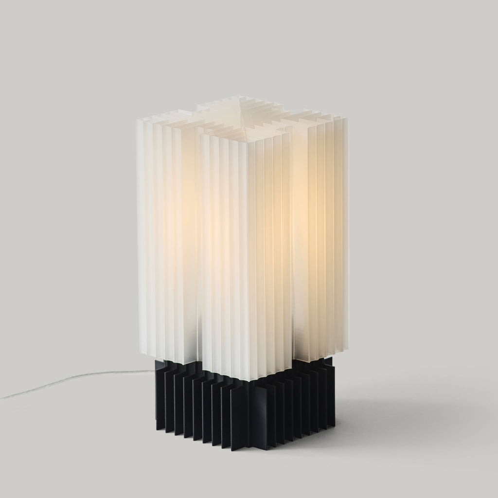 Modern table lamp with white and black design on a gray background