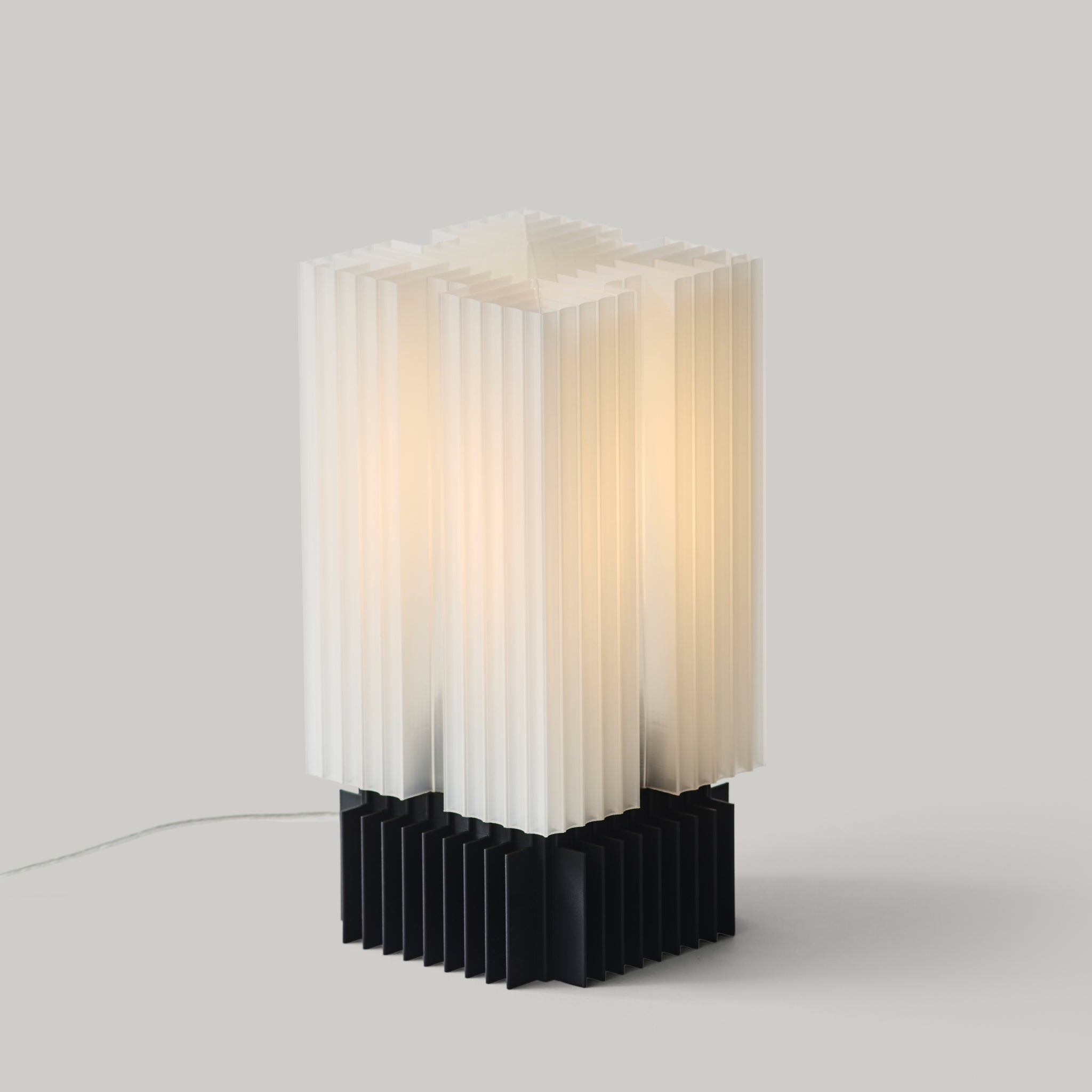 Modern table lamp with white and black design on a gray background