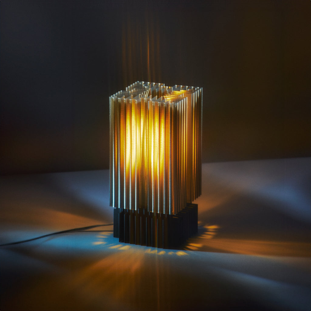 Modern table lamp with ribbed design on a dark background