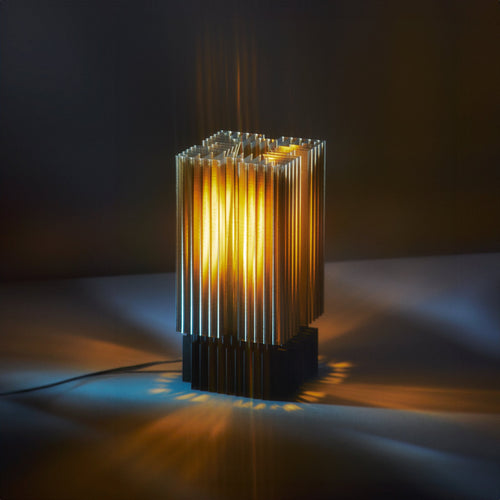 Modern table lamp with ribbed design on a dark background