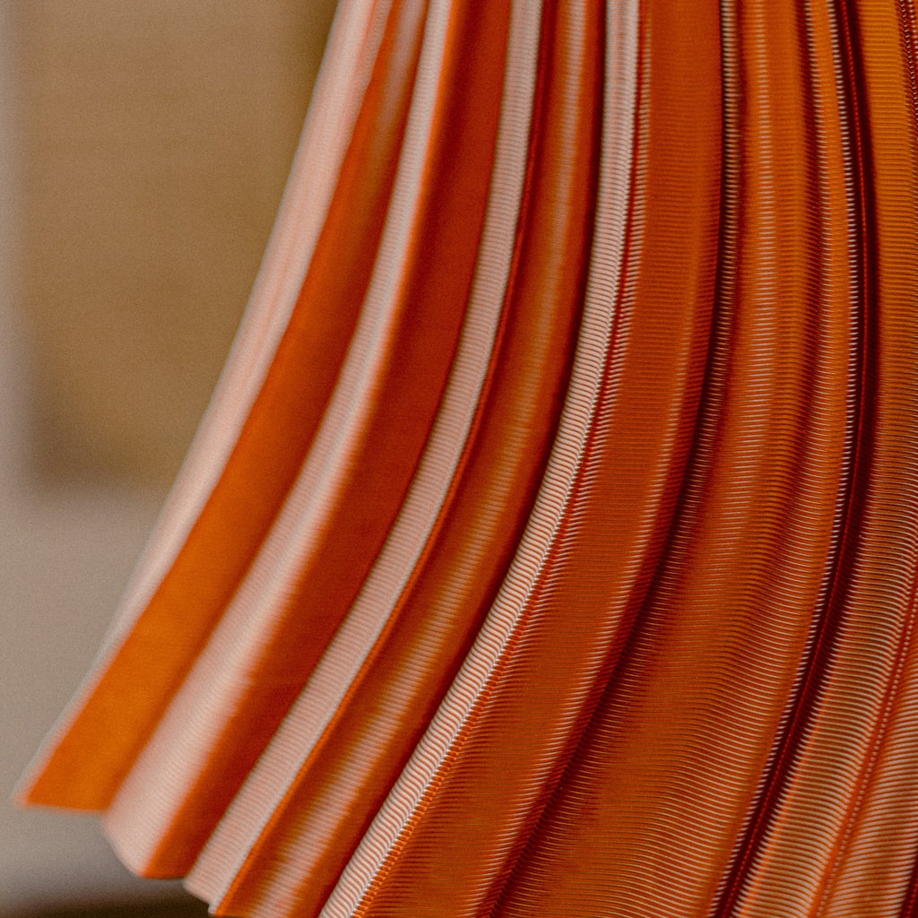 Close-up of orange fabric with a blurred background