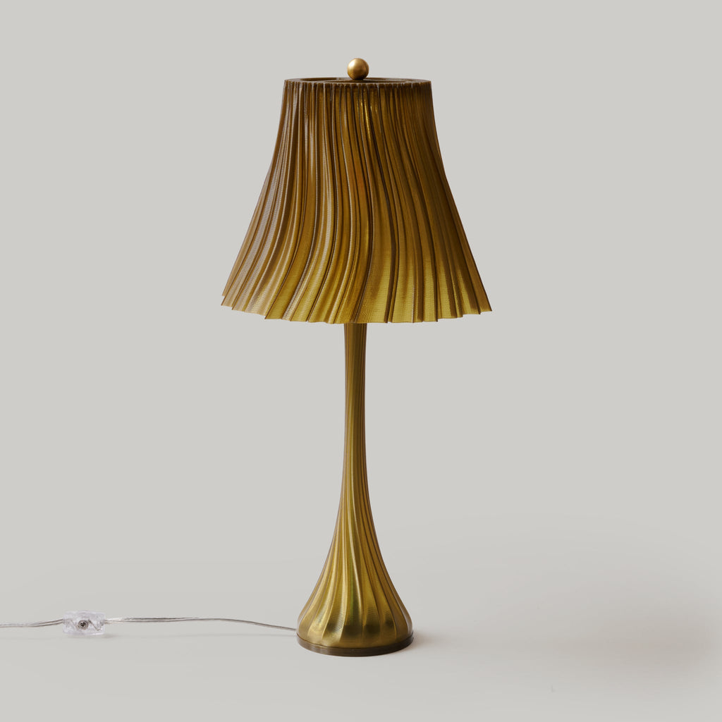Vintage-style table lamp with pleated shade on a plain background