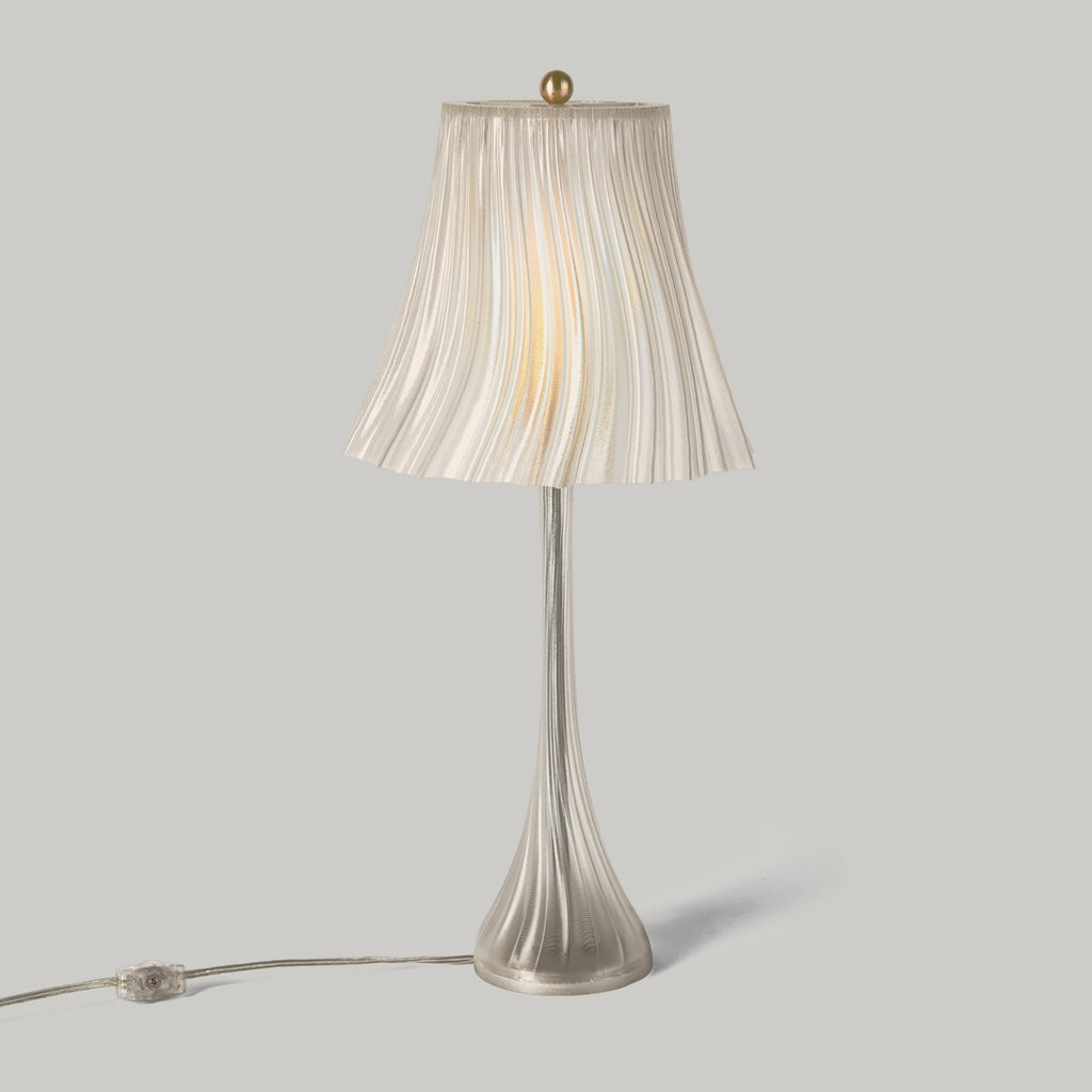 Table lamp with pleated shade on a gray background