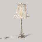 Table lamp with pleated shade on a gray background