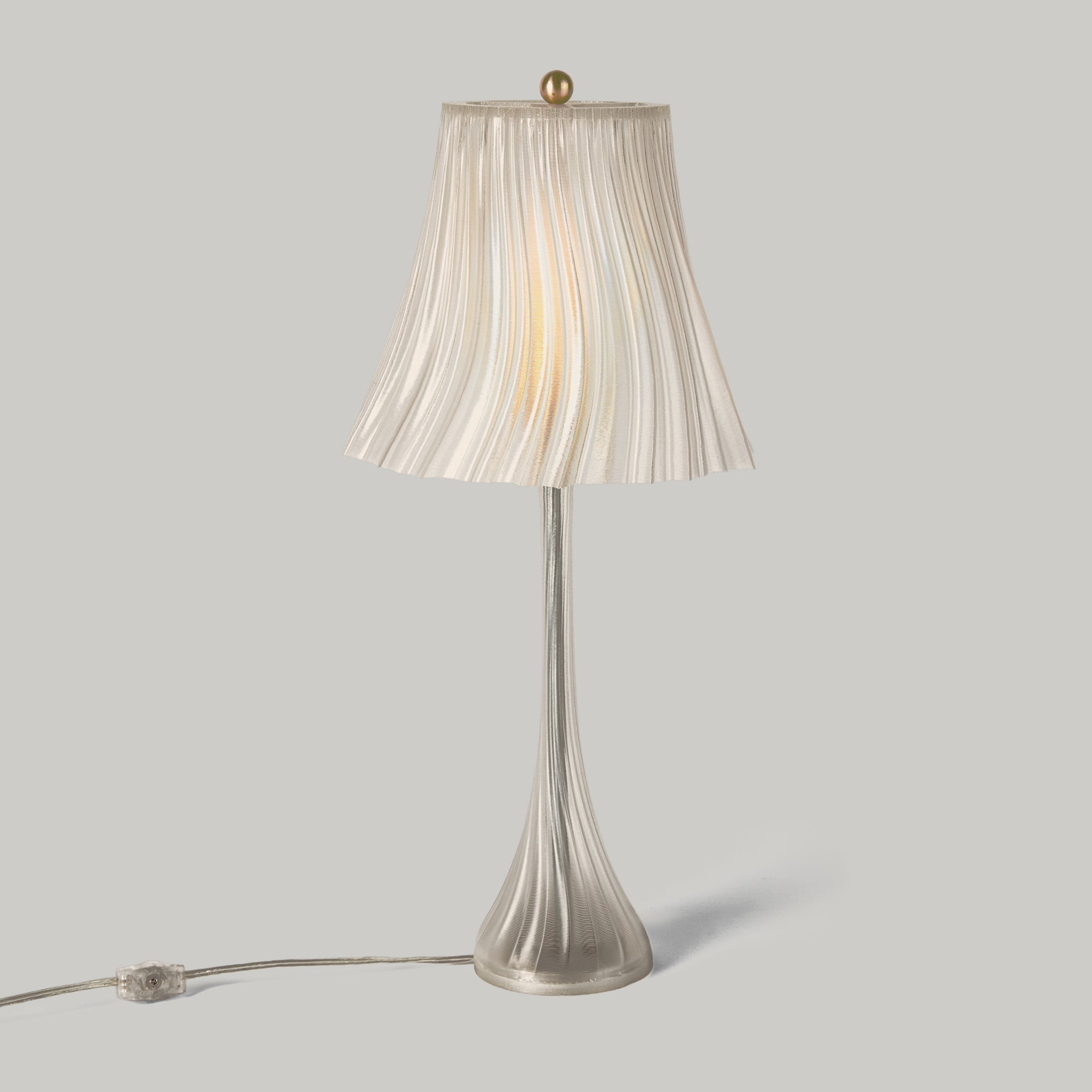 Table lamp with pleated shade on a gray background