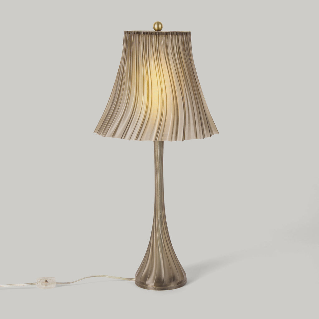 Table lamp with pleated shade on a light gray background