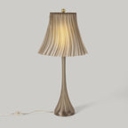 Table lamp with pleated shade on a light gray background