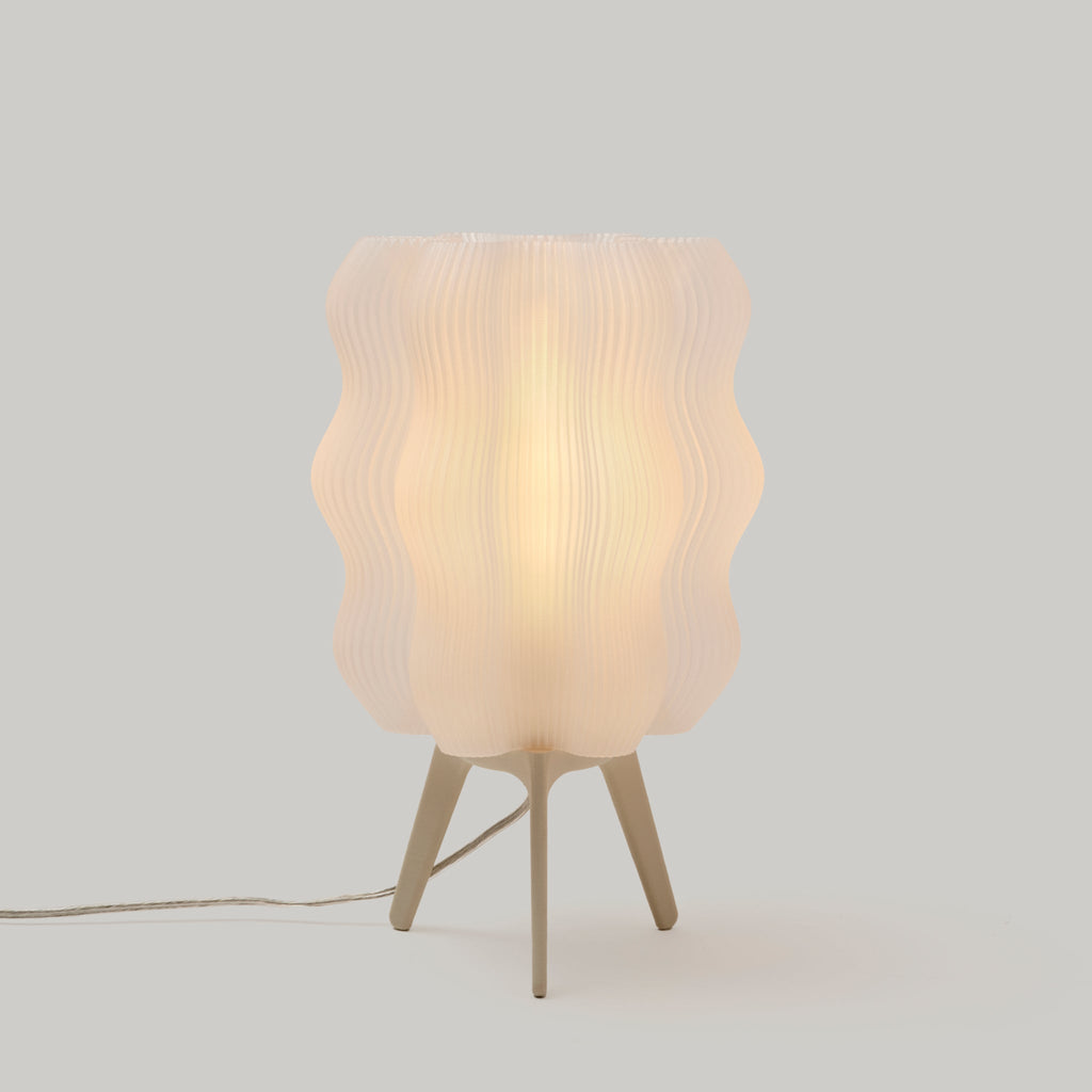Table lamp with wavy design on a light gray background