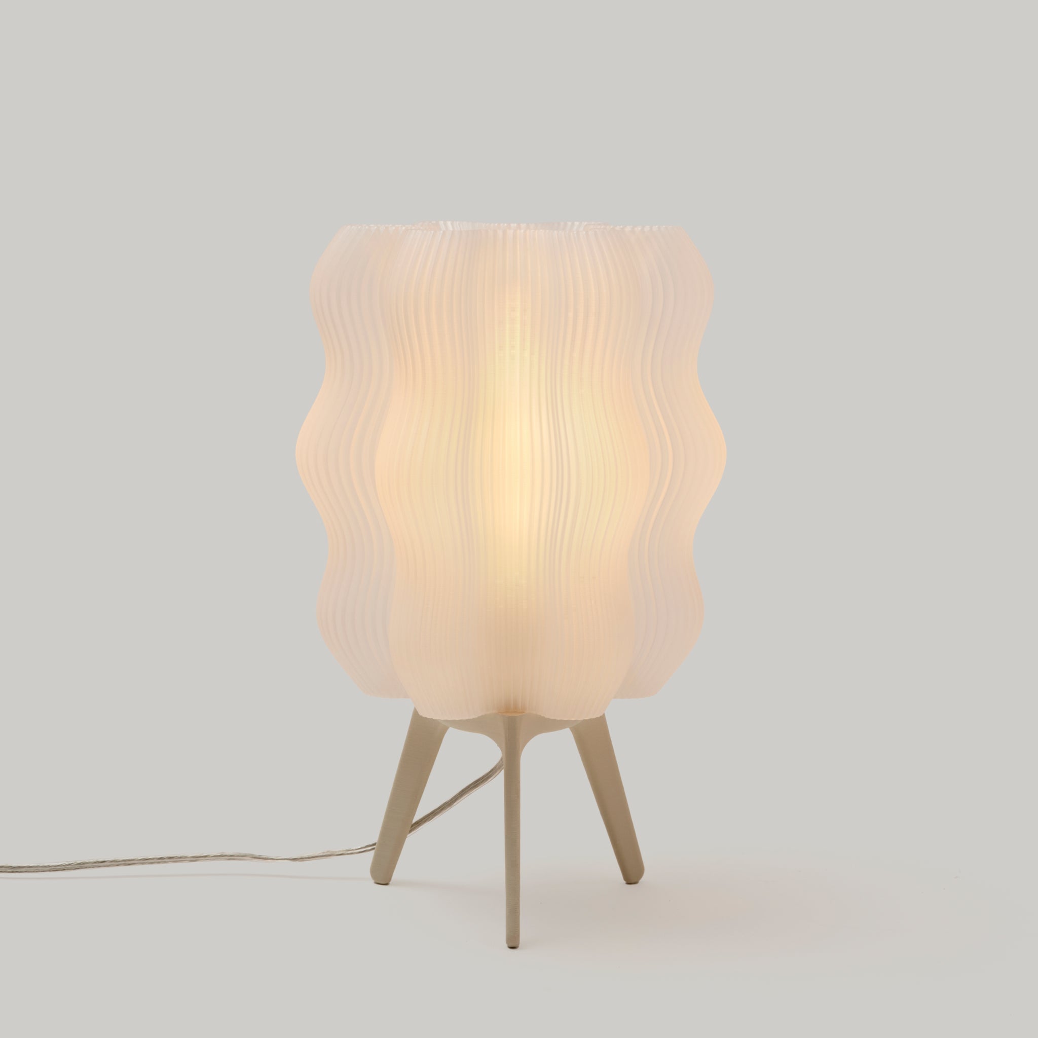 Table lamp with wavy design on a light gray background