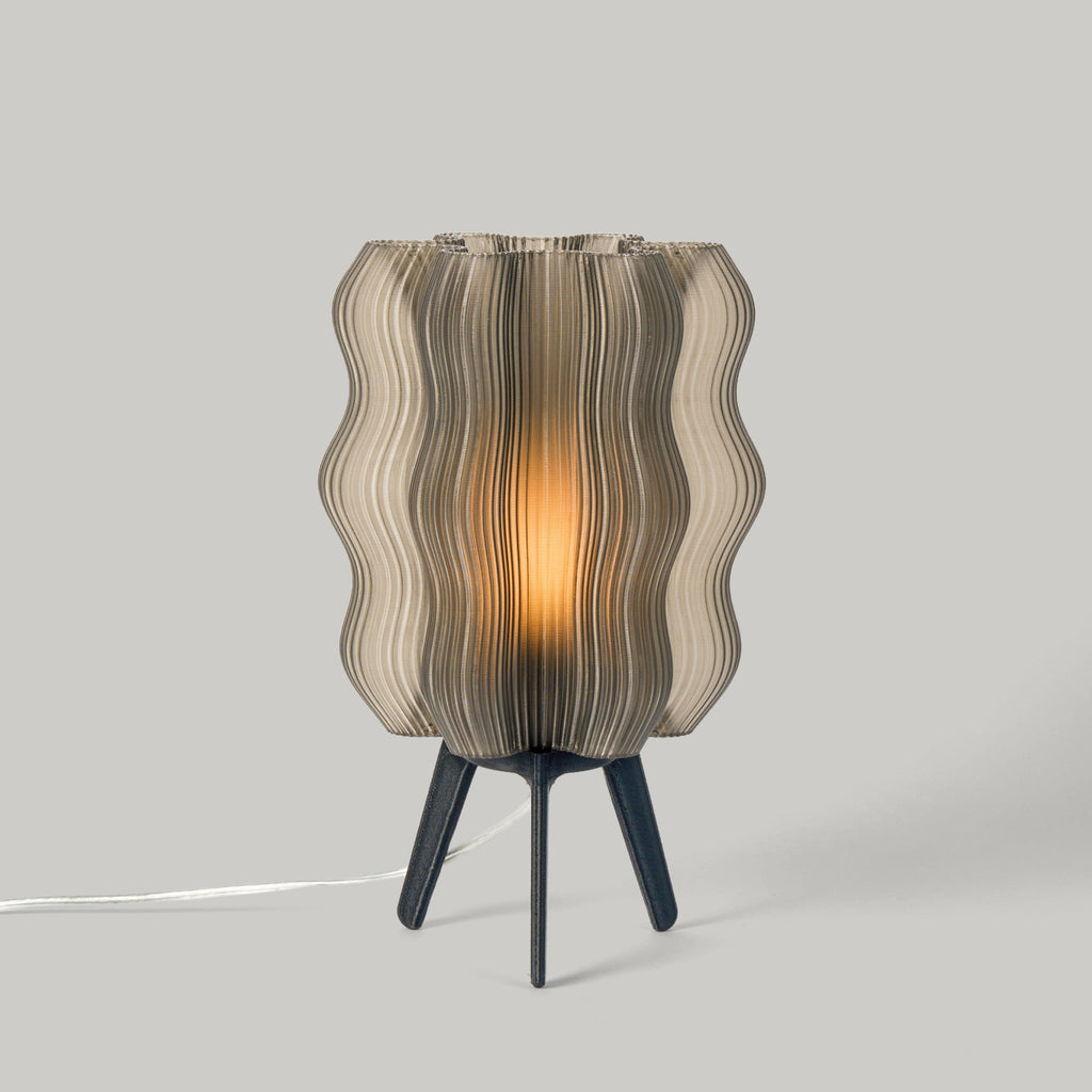 Table lamp with wavy glass shade on a gray background