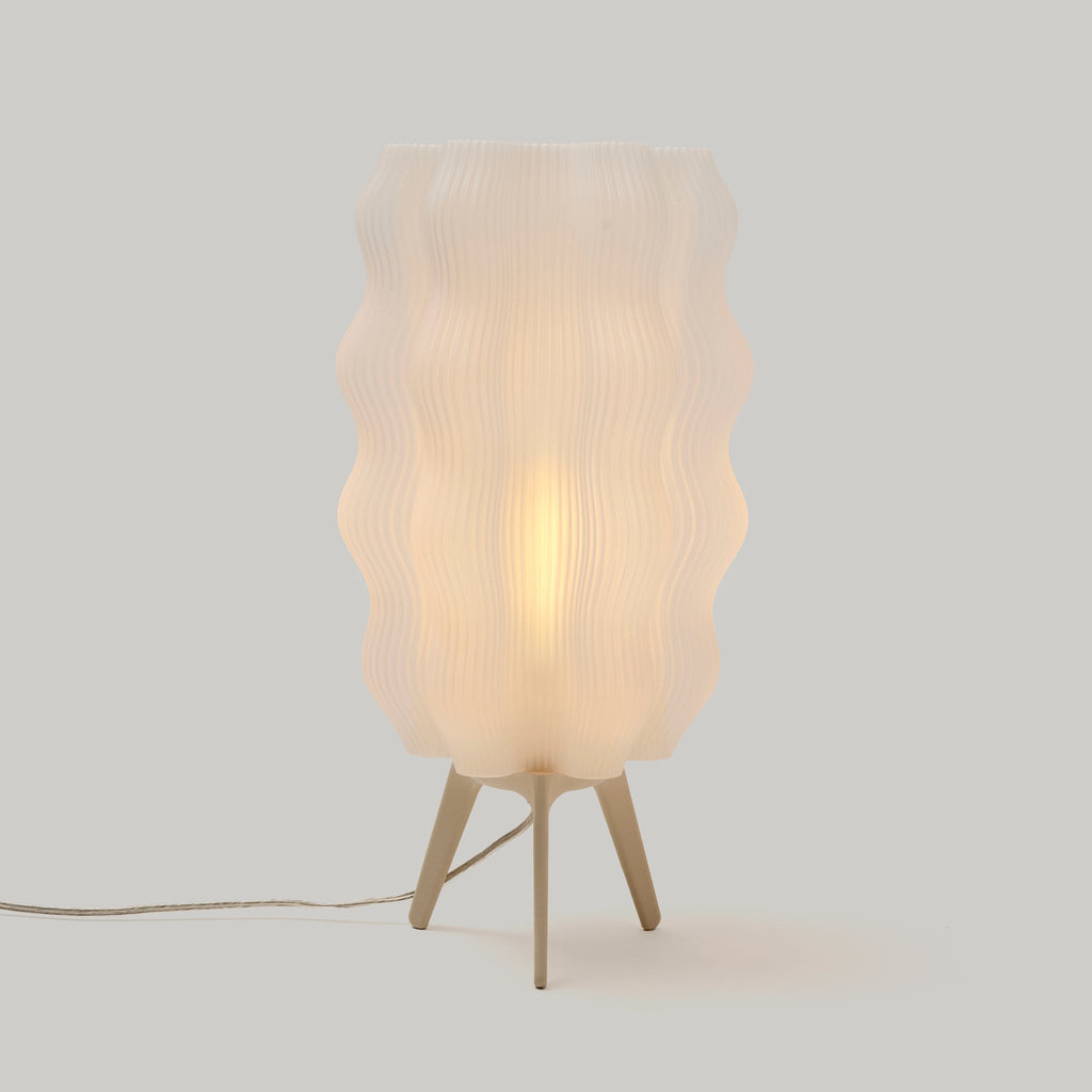 Table lamp with wavy design on a plain background